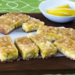 Neatly sliced sugar-free coconut lime bars on serving board
